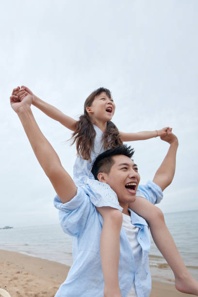 istock Happy father and daughter playing on the beach 1363738424