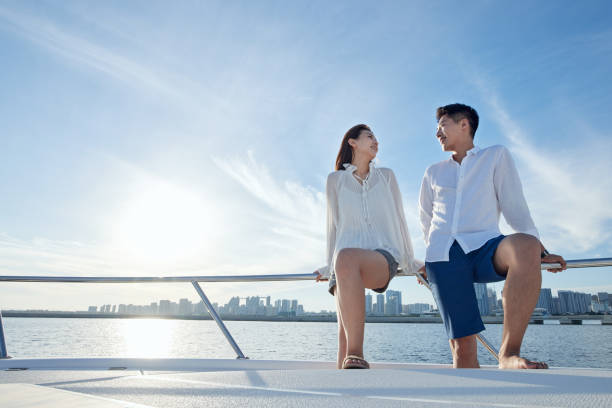 istock Romantic young couples aboard a yacht out to sea 1363738469