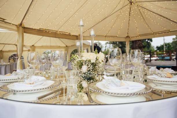 istock Luxurious restaurant. Luxurious interior, white tables, serving dishes and glasses for guests 1363739121