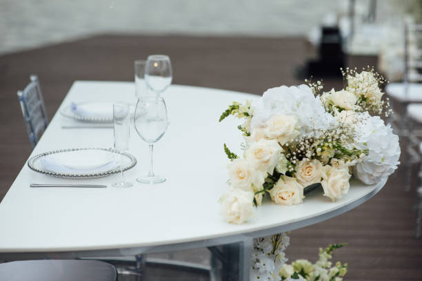 istock Luxurious restaurant. Luxurious interior, white tables, serving dishes and glasses for guests 1363739146