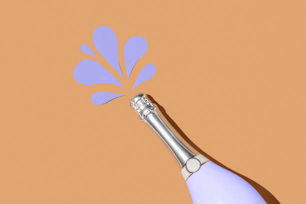 istock Very Peri champagne bottle on beige background with paper drops 1363746773