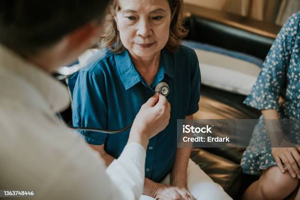 Closeup Asian Doctor Concentrate On Listening Heartbeat Of Senior Woman Stock Photo - Download Image Now