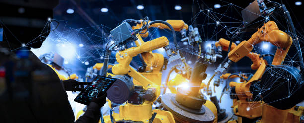 Factory Female Industrial Engineer working with automation robot arms machine in intelligent factory industrial on real time monitoring system software.Digital future manufacture. stock photo