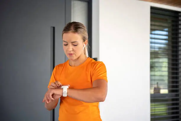 Photo of Woman checking the time on her wrist watch