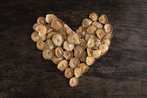 heart shape made from dried shitake mushrooms on a rustic wooden table - date night imagens e fotografias de stock