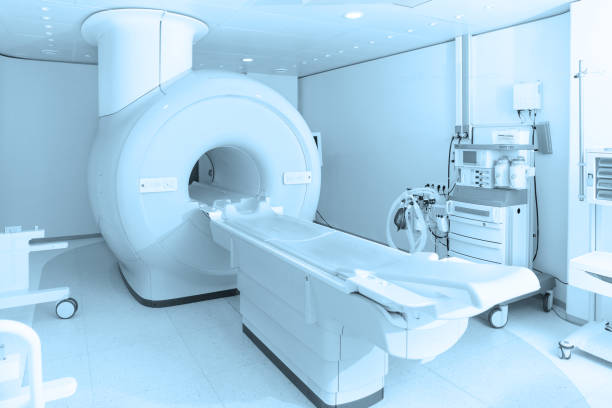 Medical CT or MRI Scan in the modern hospital laboratory. Interior of radiography department. Technologically advanced equipment in white room. Magnetic resonance diagnostics machine Medical CT or MRI Scan in the modern hospital laboratory. Interior of radiography department. Technologically advanced equipment in white room. Magnetic resonance diagnostics machine. x ray image medical occupation technician nurse stock pictures, royalty-free photos & images