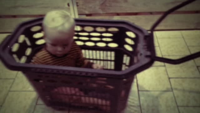 Hilarious footage of a child in a shopping basket trolley being pulled around a shop