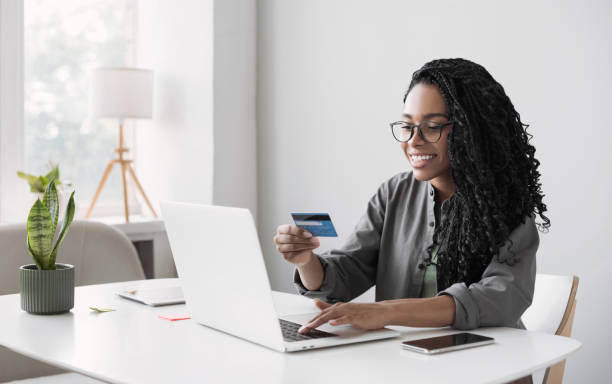 mujer usando computadora portátil y pagando con tarjeta de crédito. concepto de compra en línea. - banca electrónica fotografías e imágenes de stock