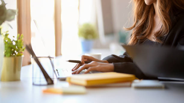 istock Business woman typing on notebook computer keyboard. 1363753092