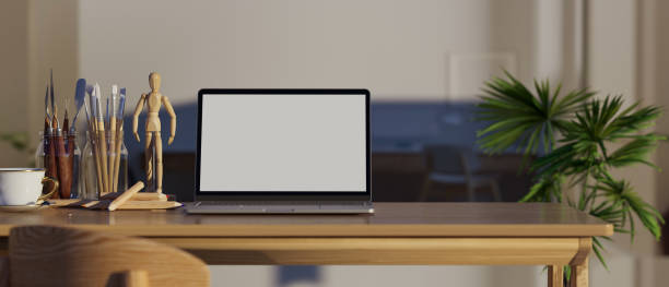 istock Workspace with portable laptop computer mockup and copy space on wooden desk. 1363753337