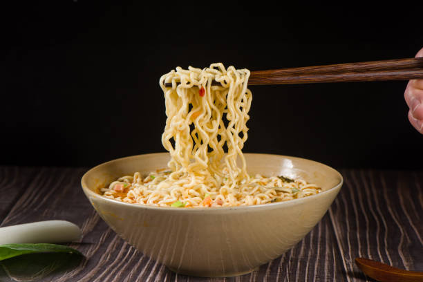 istock chopsticks with cooked instant noodles on black background 1363754337