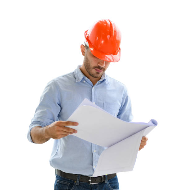 istock Portrait of construction engineer manager workers in orange hardhat and looking layout plan isolated on white background. 1363754388