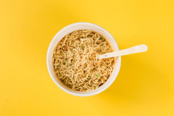 istock cooked instant noodles with fork on yellow background 1363754390