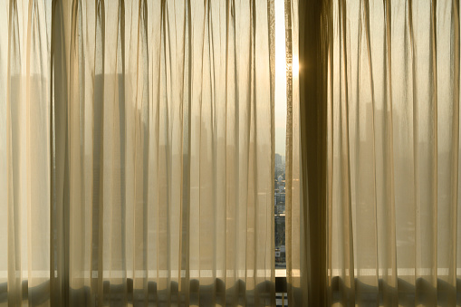 Sheer curtains with cityscape onbackground. transparent curtain in cozy room home, interior design concept