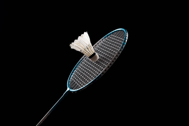 Badminton shuttlecock and badminton racket on black background