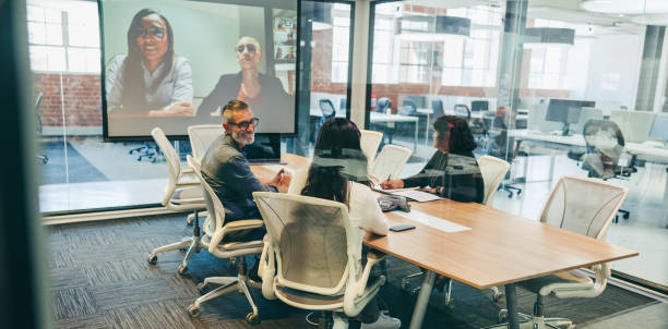 istock Happy businesspeople attending a virtual briefing with their partners 1363754648