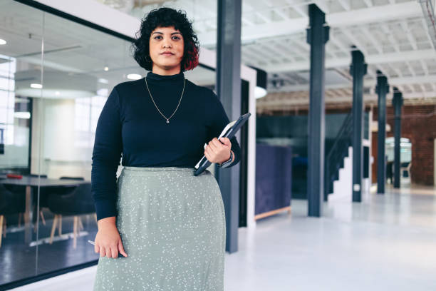 istock Confident businesswoman looking at the camera in a modern workplace 1363754784