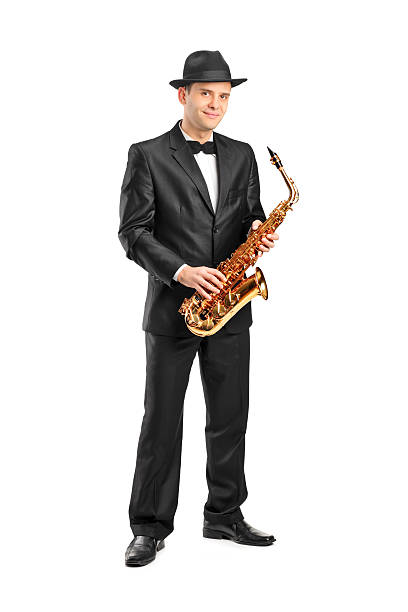 istock Man in a suit holding saxophone 136375498