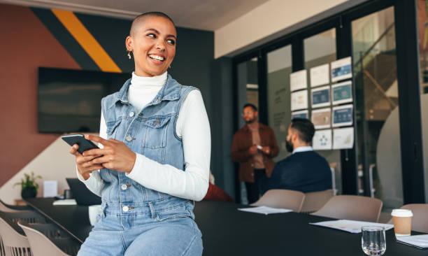 Excited businesswoman looking away thoughtfully