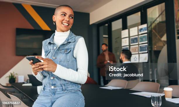 Excited Businesswoman Looking Away Thoughtfully Stock Photo - Download Image Now - Candid, Office, Teamwork