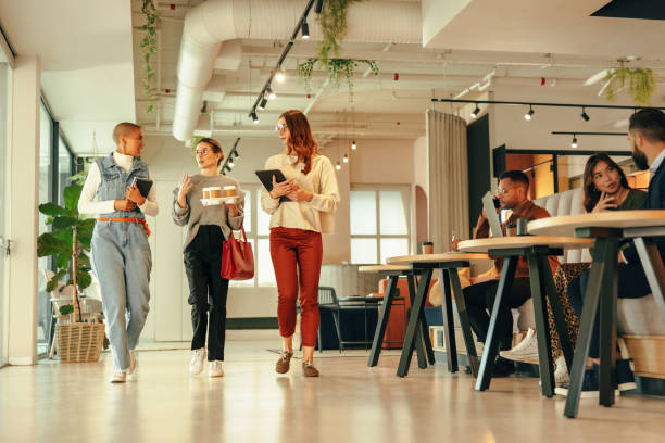 istock Group of businesswomen walking through a modern office 1363756559