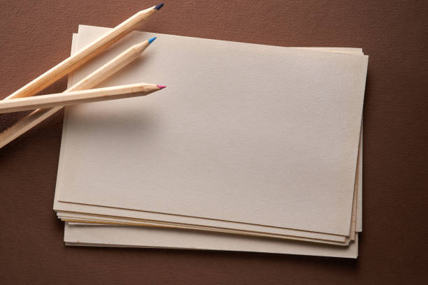 sketch pad with color pencils on brown background