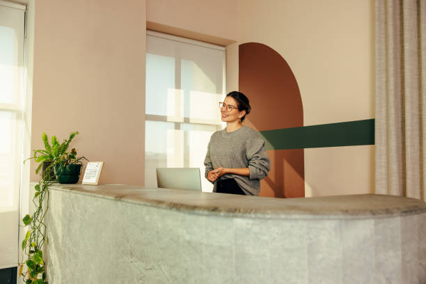 istock Friendly receptionist welcoming a client in an office 1363756703