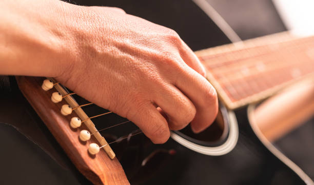 istock woman playing guitar 1363756940