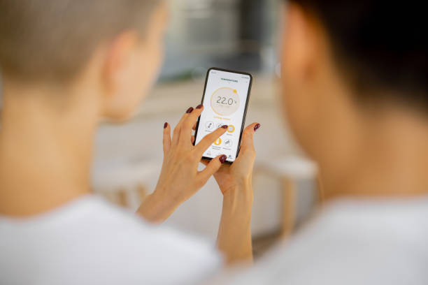 istock Couple using app of smart home on smartphone 1363758268