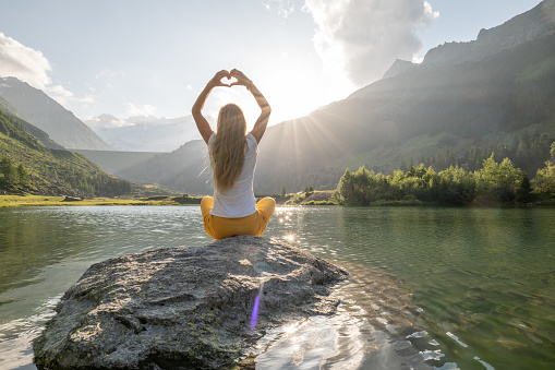 Woman practices yoga in nature, she connects body and mind to balance