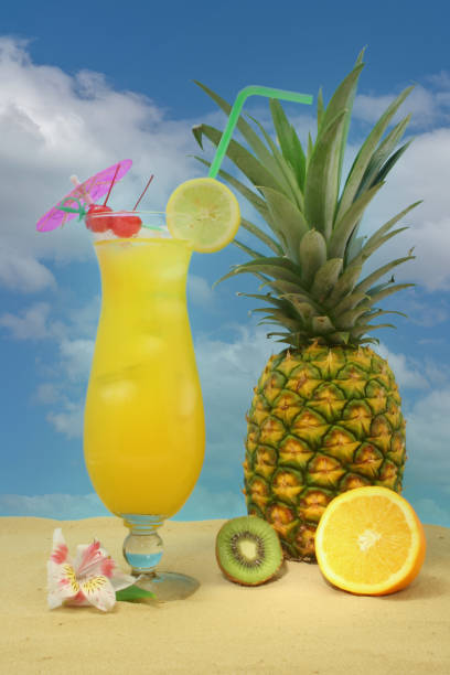 istock Pineapple, Tropical Drink and Fruit on Sand With Sky 1363763046