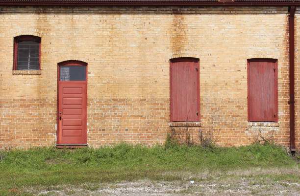 istock Close-up Building Detail Historical Brick Wall With Doors and Windows 1363763083