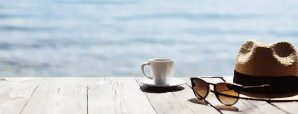 Photo of Cup of coffee with a sea at the background, travel, vacations concept