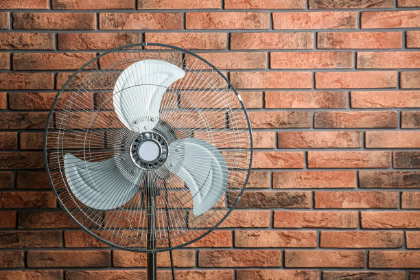 istock Electric fan near brick wall, space for text. Summer heat 1363763331
