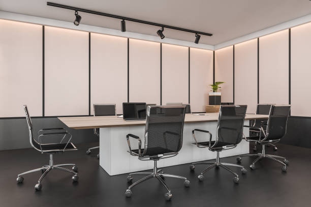istock Corner view on dark office room interior with, desk, laptops 1363764339