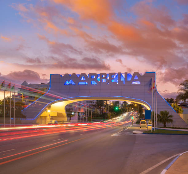istock Marbella arch welcome sign at sunset with traffic light beams in 1363764360