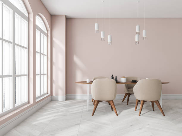 istock Pink and wooden dining room interior with table and chairs, window 1363764492