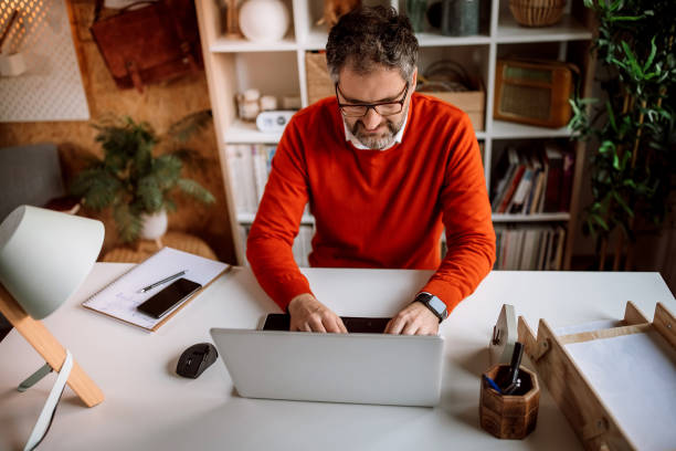 istock Businessman working on laptop in his home office 1363765765