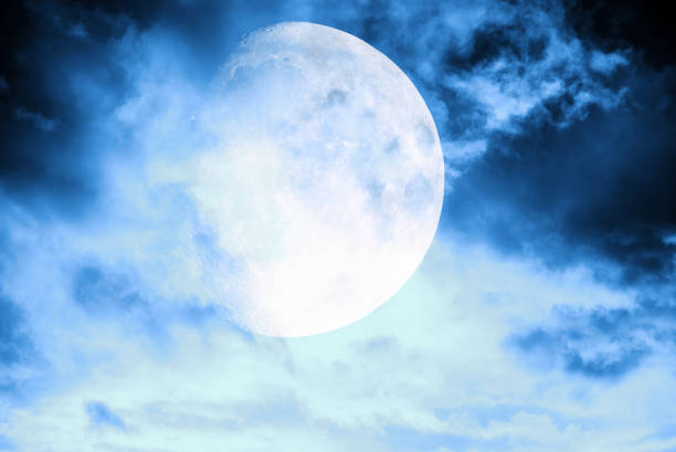 istock Magic blue night sky landscape with clouds and fullmoon and stars closeup. 1363765820