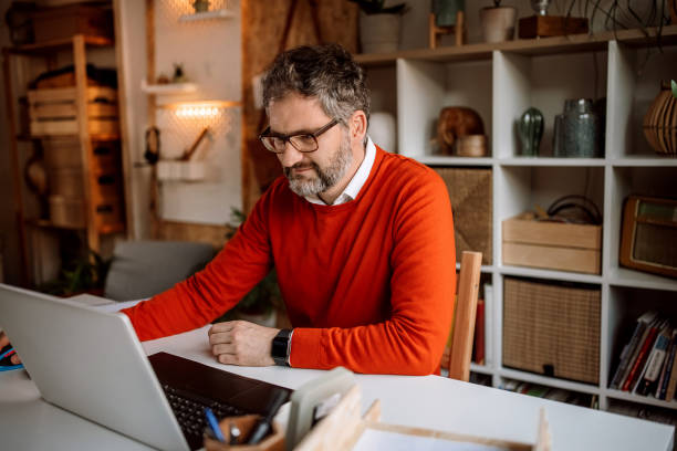 istock Businessman working on laptop in his home office 1363765849