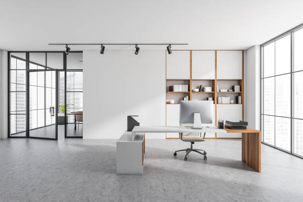 istock Bright office room interior with empty white wall, desk, armchair 1363765903