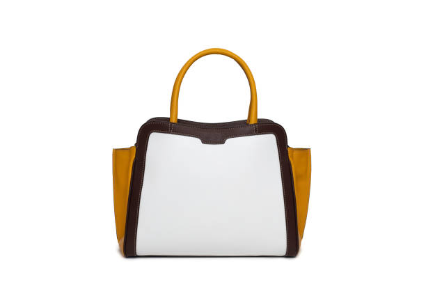istock Elegant light brown leather women's handbag on white table 1363767159
