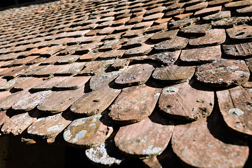 Shallow depth of field (selective focus) details of Transylvanian saxon traditional clay tiles.