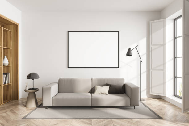 istock White guest room interior with sofa and shelf, window and mockup poster 1363767706