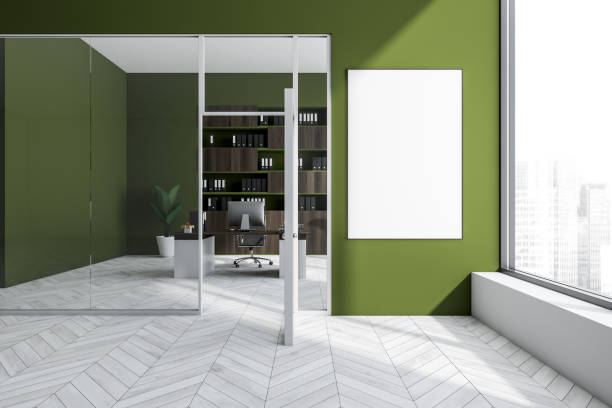istock Bright office interior with empty white poster, desk, glass door 1363767876
