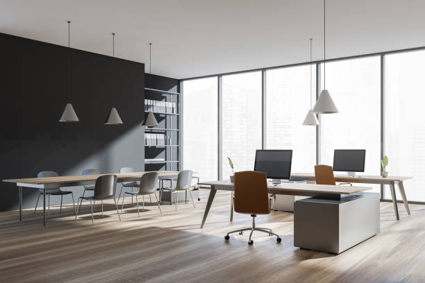 istock Corner view on dark office room interior with desk, desktops 1363768454