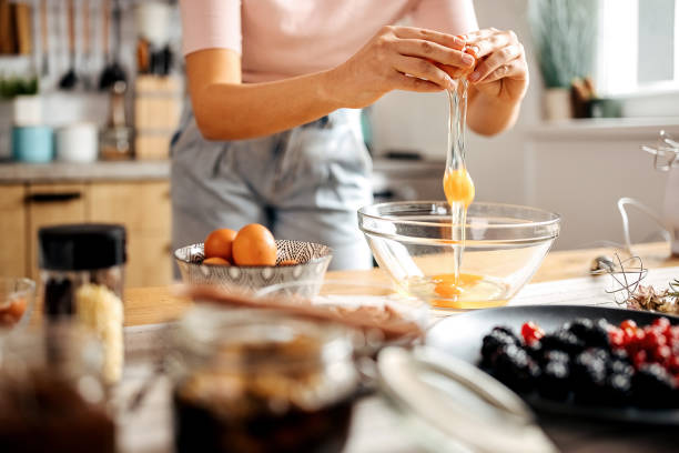 istock Young unrecognisable woman making a cake in her home kitchen 1363770144