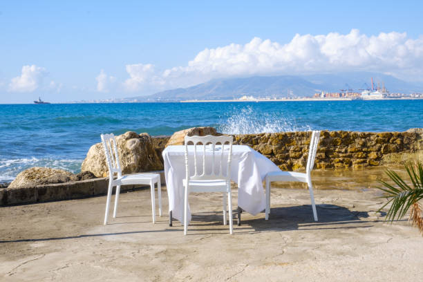 Viewpoint towards the sea in Malaga with blue sea and horizon in the background and waves.