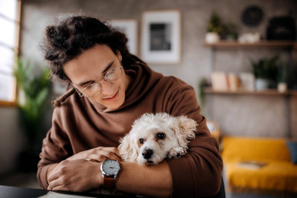 istock Young handsome man bonding with his cute little dog 1363770965