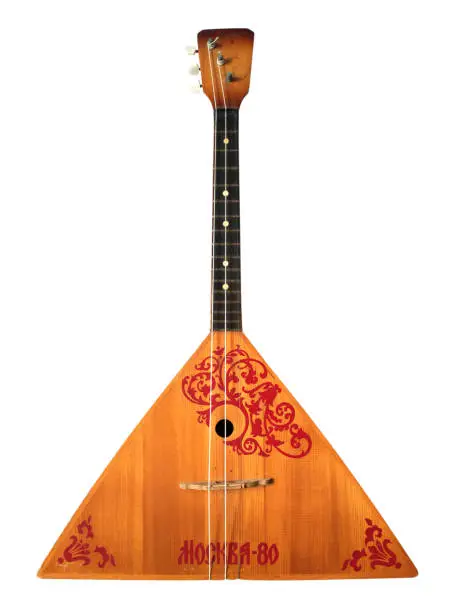 Balalaika Russian folk string musical instrument isolated on white background. Yellow balalaika with red traditional pattern.